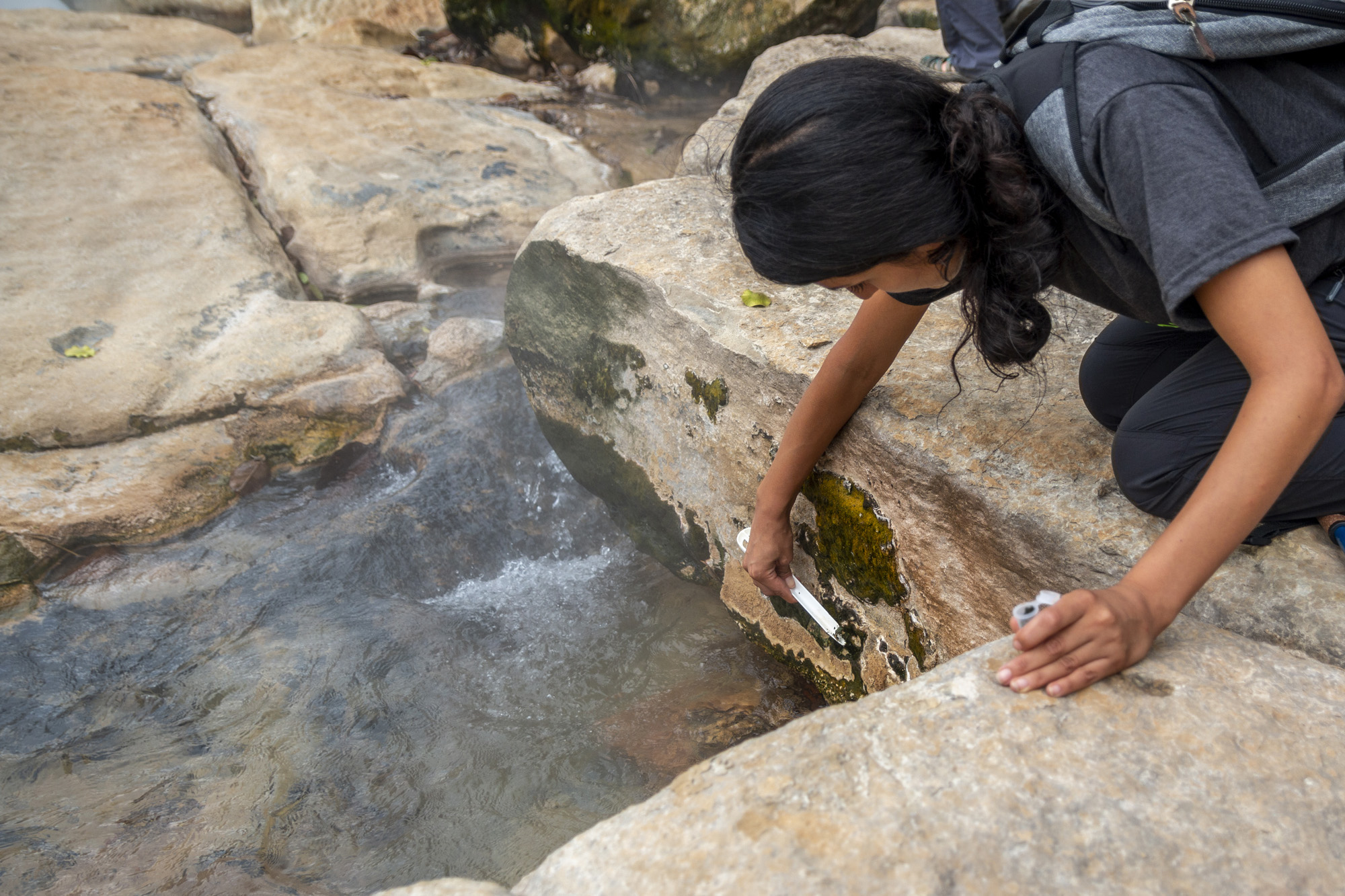Rosa Vasquez collects samples from the Boiling River