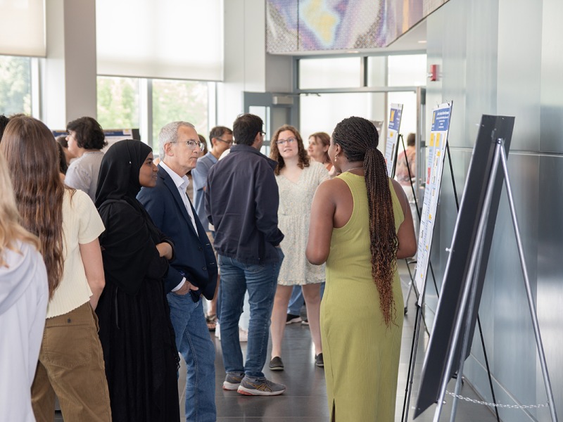 Scientists presenting at a poster session in the LSI