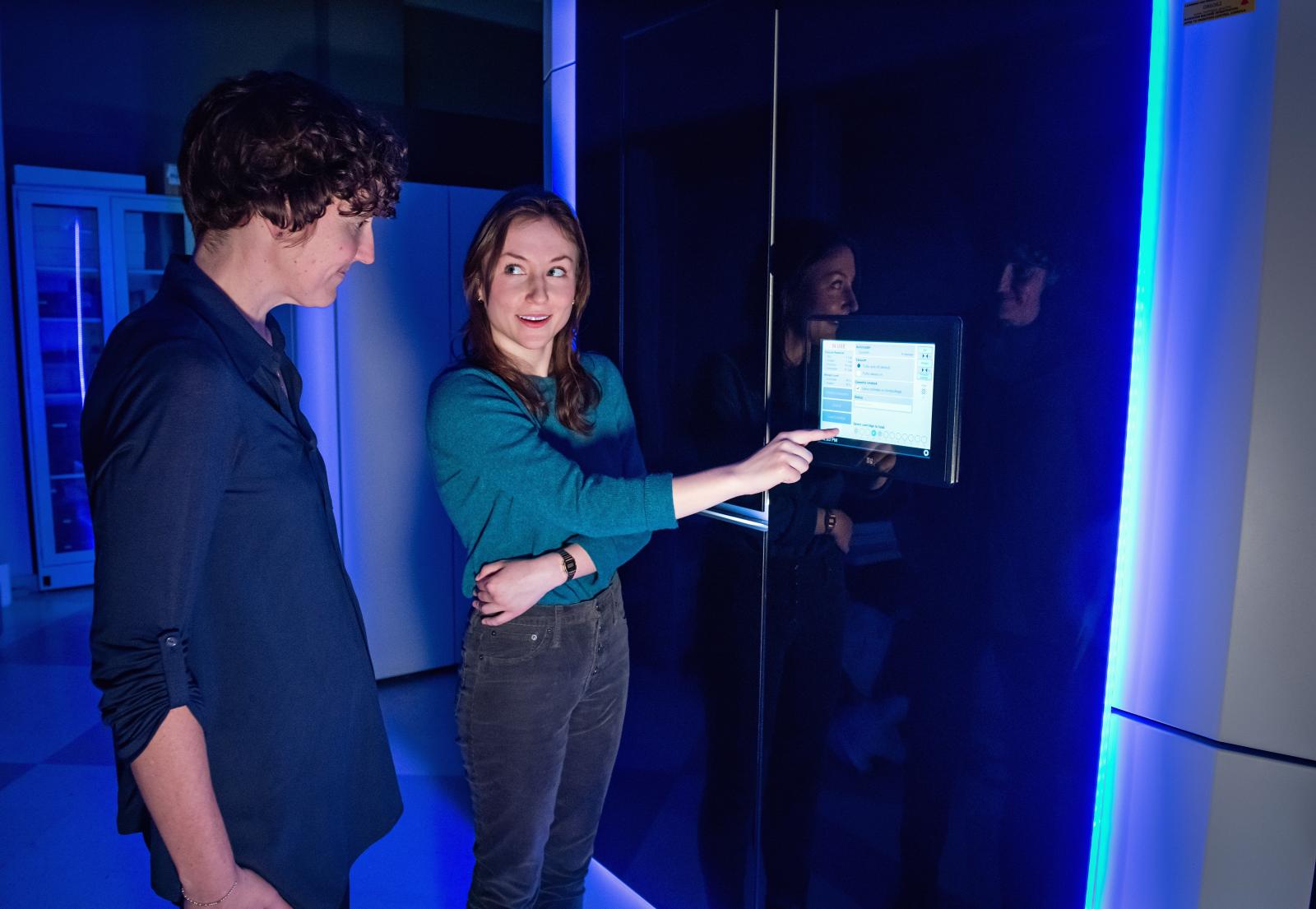 Melanie Ohi, Ph.D., and Jacquelyn Roberts examine the Titan Krios microscope